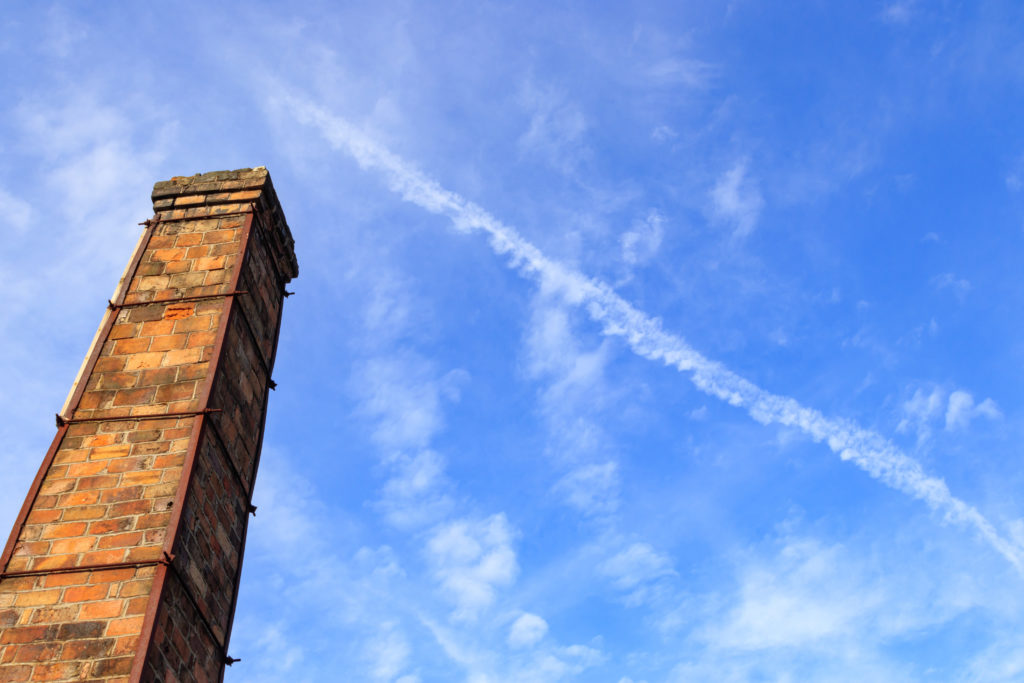 smokestack in front of a clear blue sky 