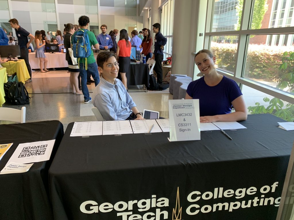 LMC 3432 instructors Jonathan Shelley and Katie Schaag greet attendees at the sign-in table at the Spring 2019 Expo