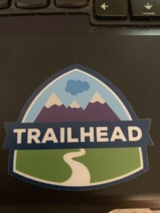 A sticker marked "TRAILHEAD" shows a path leading up to three mountains.