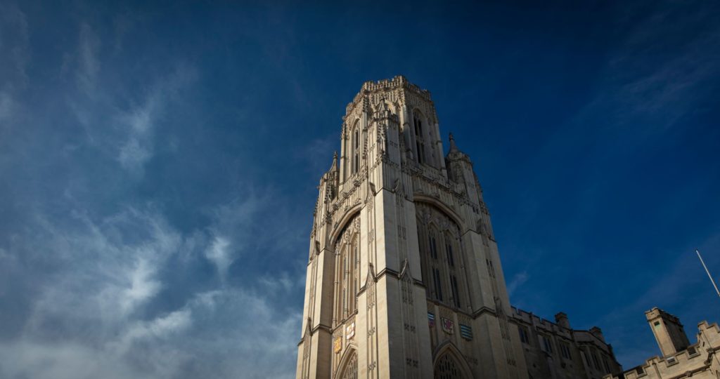 Image of a university tower against a blue sky