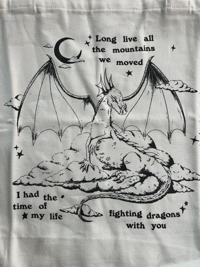 Print with an illustration of a dragon and a moon with the lyrics "Long live all the mountains we moved. I had the time of my life fighting dragons with you" from the song Long Live by Taylor Swift, initially on her 2010 album Speak Now