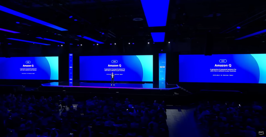 AWS CEO Adam Selipsky on the 2023 re:Invent keynote stage surrounded by screens that introduce Amazon Q