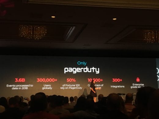 Jennifer Tejada on stage with a slide showing PagerDuty's key operational stats.