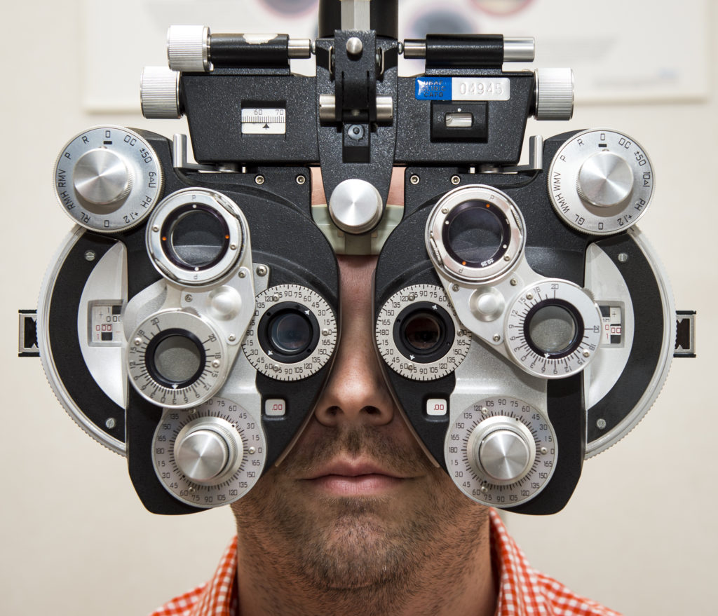 patient looking through ophthalmic equipment