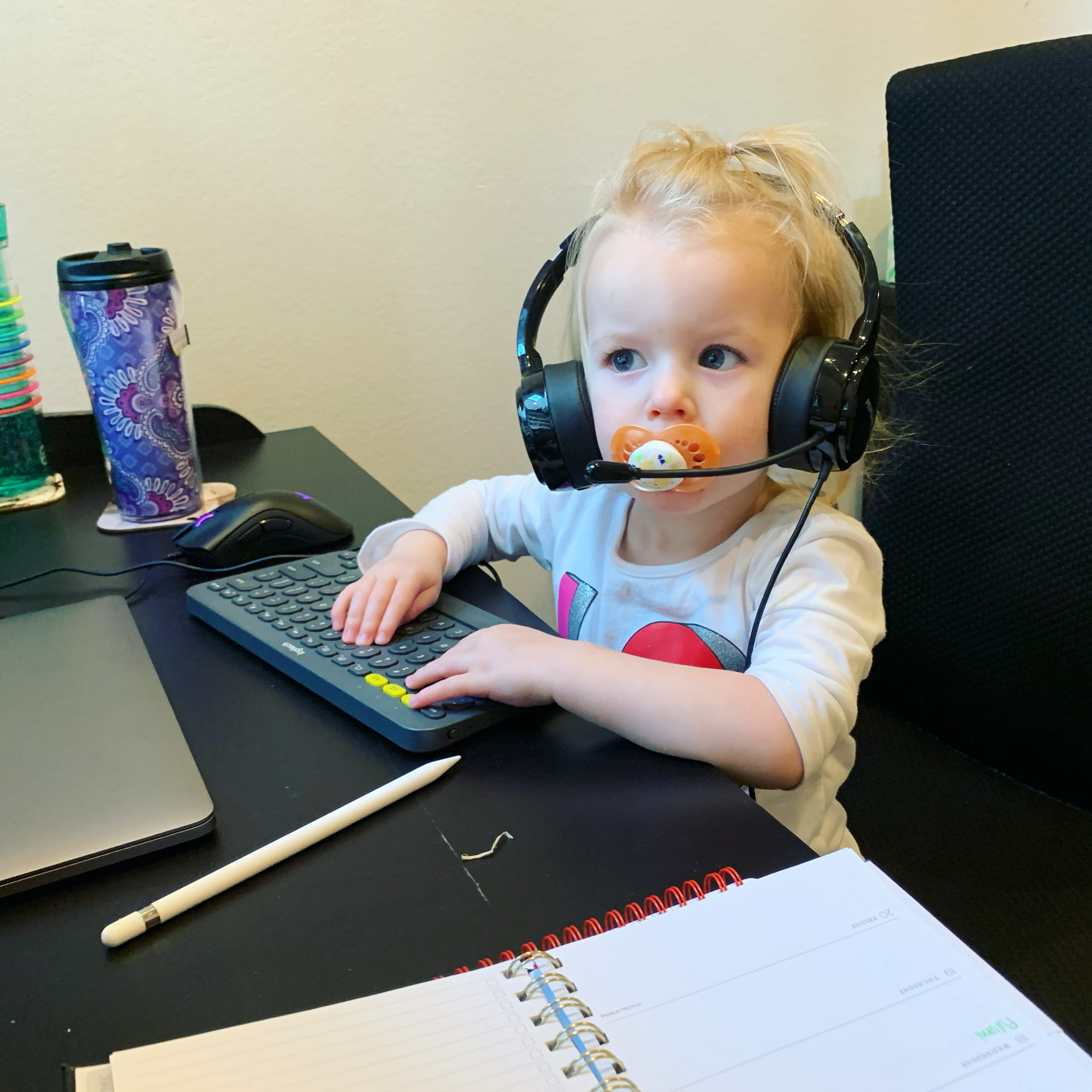 Toddler wearing conference call headset