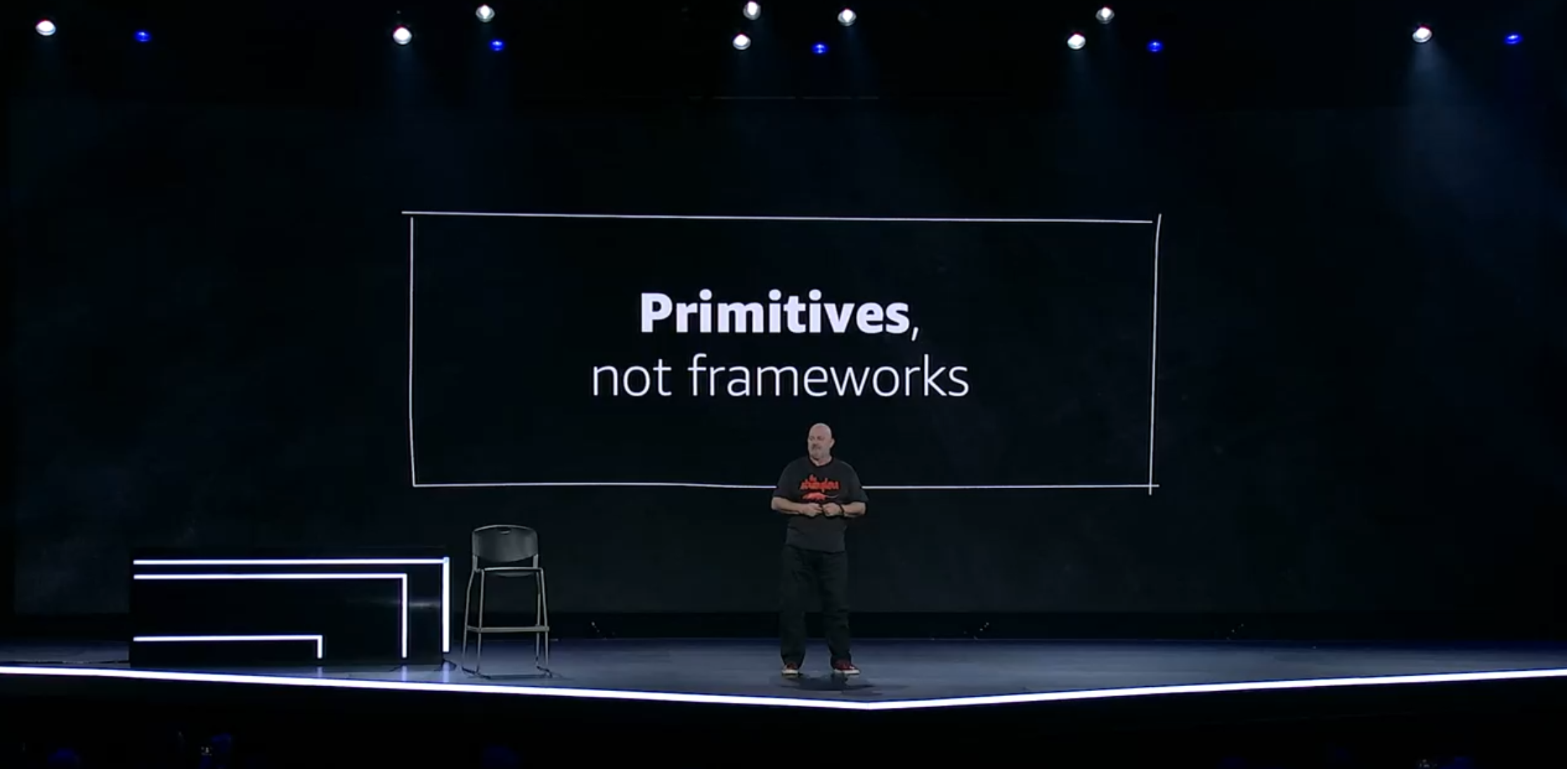 Werner on stage with slide, "Primitives, not frameworks"