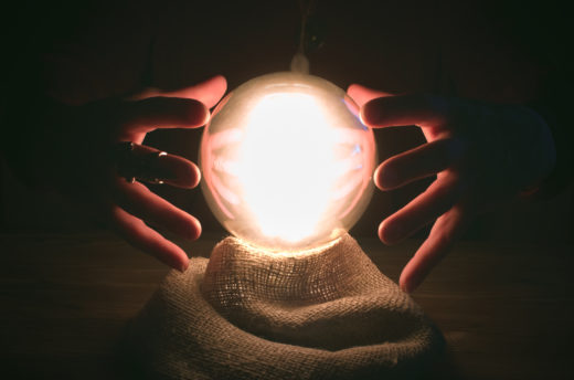 glowing crystal ball and fortune teller hands